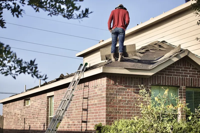 Professional roofer working on a residential roof in Farmers Branch